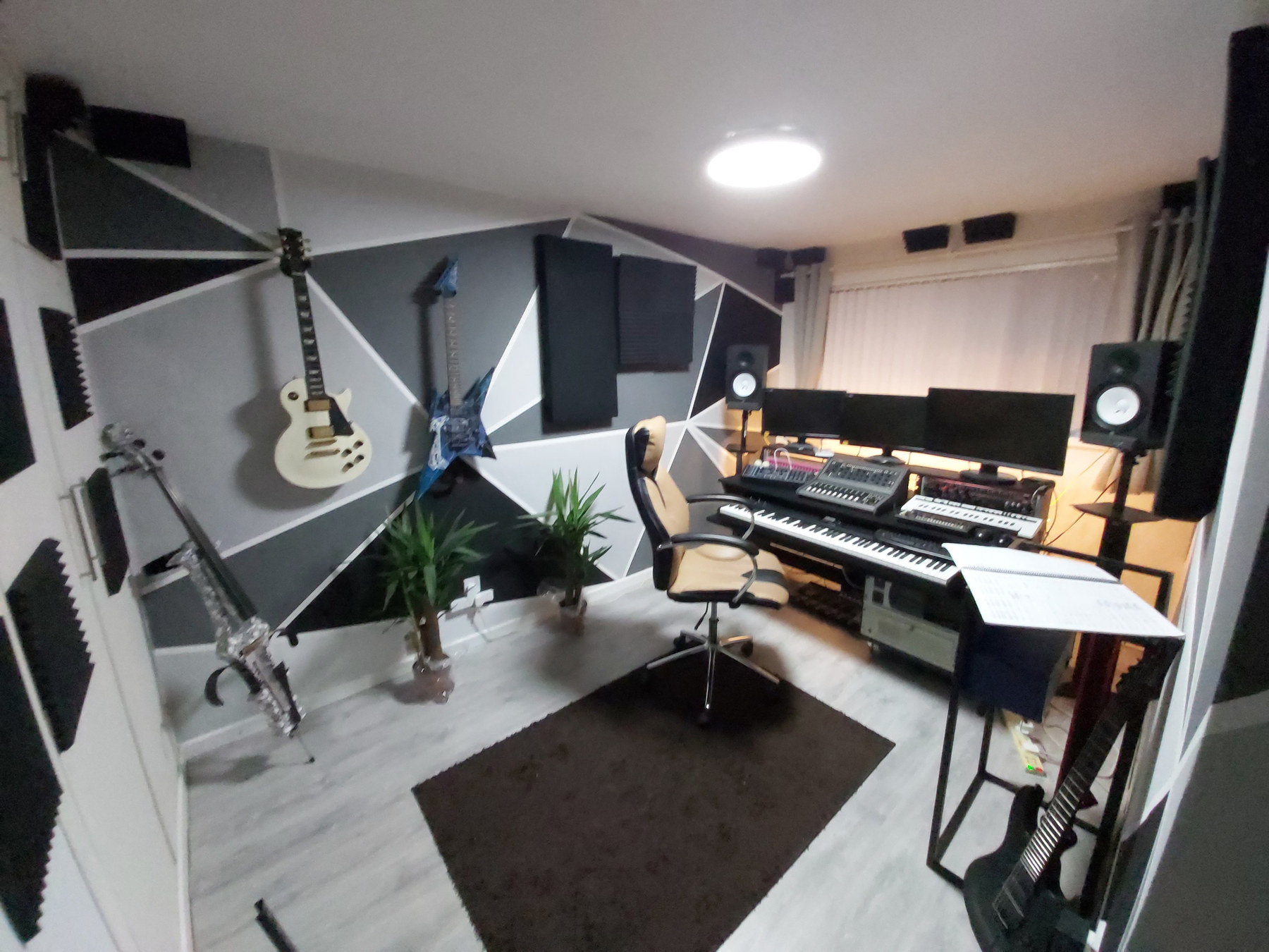 Recording studio interior with a keyboard, speakers and guitars